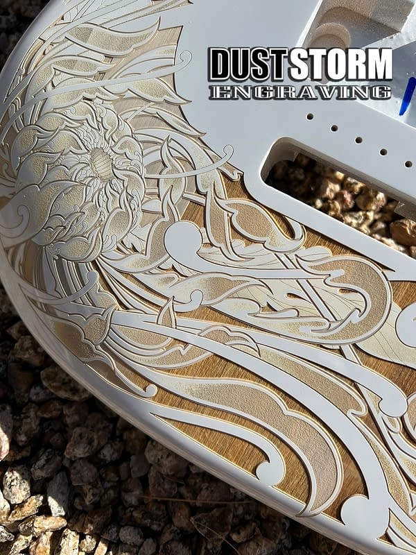 Glossy white Fender Stratocaster guitar body with laser engraved natural wood color floral design by Dust Storm Engraving