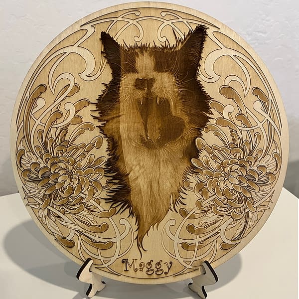 Roaring tuxedo cat portrait framed with flowers and name Maggy Laser engraved on Poplar Wood Circle sitting on wood stands